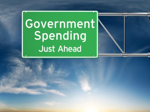 Government spending just ahead . Street exit sign showing the in