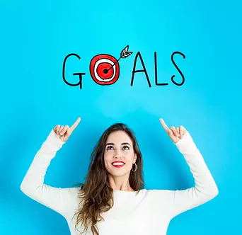 woman pointing at the word "goals" above her head